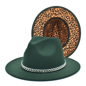 Close-up of wool fedora with silver chain trim and leopard print inner lining