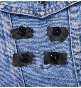 Detail of four pins showing the butterfly clasp and pin back on blue denim fabric