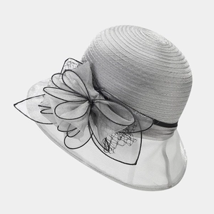 Detail of silver organza mesh flower and oversized bow on elegant formal sun hat