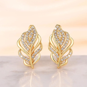 Macro shot of gold wheat ear earrings with pave-set white cubic zirconia stones