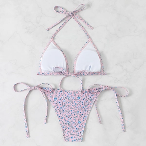 Detailed view of pink floral bikini top showing removable circular chest pads and straps