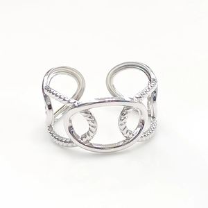 Detail of silver stainless steel open ring with oval link and twisted rope design
