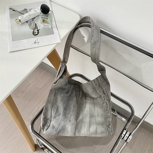 Detail of gray tie-dye canvas tote bag showing soft texture and adjustable silver metal buckle