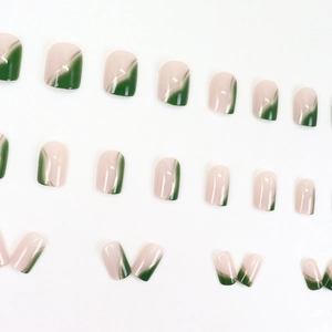 Short round-square press-on nails featuring pink and green gradient with gold accents