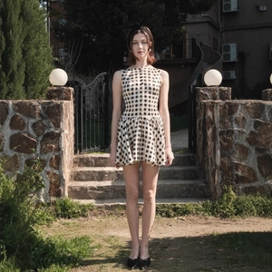 Plaid sleeveless mini dress with button details and cinched waist in black and white