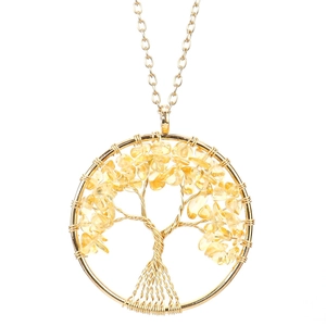 Detail of handmade Tree of Life pendant with gold wire and yellow crystal stones