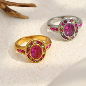Detail of 18K gold and silver rings with oval rose stone and multicolored zircons