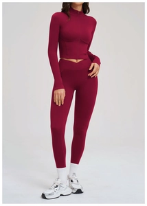 Close-up of burgundy yoga set featuring high-waist cross waistband and zip-up jacket
