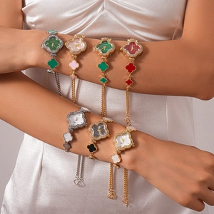 Detail of stacked clover leaf jewelry watches with crystal inlay on silk fabric