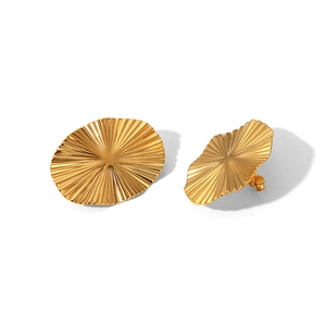 Detailed view of gold-plated stainless steel shell-shaped earrings with ribbed texture