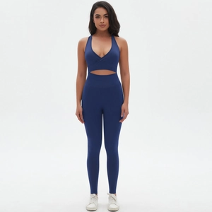 Deep blue seamless yoga set with V-neck sports bra and high-waisted leggings on model