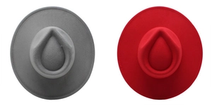 Top view of dark grey and bright red wool felt fedora hats with wide brims on white background
