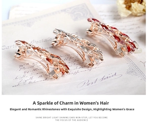 Detailed macro view of rhinestone leaf hair clips in red and champagne on vintage paper