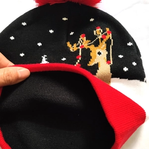 Detailed view of the double-layer knit lining and festive reindeer jacquard pattern