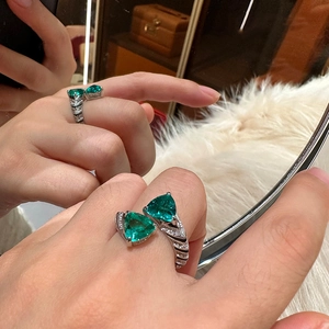 Detailed macro view of the double triangle green zircon stones and ribbed silver ring band