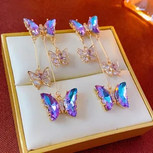 Elegant gold-plated butterfly tassel earrings with blue aurora crystal and long drop chains