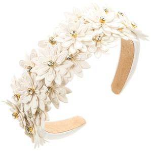 Macro detail of layered white leather flowers with crystal centers on wide headband