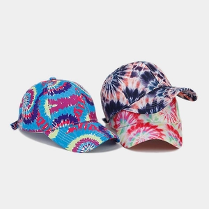 Detailed close-up showing three colorful tie-dye cotton baseball caps with curved brims