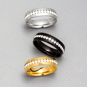 Sleek stainless steel eternity rings in silver, black, and gold with sparkling cubic zirconia