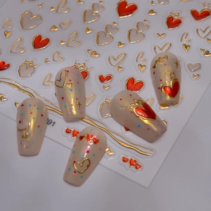 Macro shot of liquid star and heart nail stickers with gold outlines and 3D relief effects
