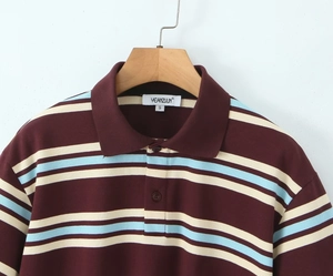 Detail of striped polo shirt featuring burgundy and blue stripes with three-button collar