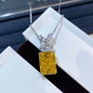 Macro shot of square yellow ice-cut zirconia pendant on S925 sterling silver chain
