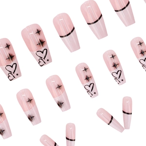 Pink and black long coffin press-on nails with heart and star patterns on white background