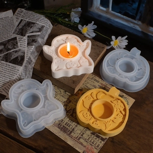 Detailed view of Halloween pumpkin and ghost silicone molds used as candle holders