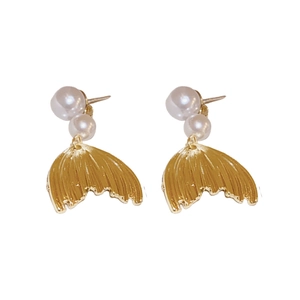 Elegant gold fishtail pearl earrings with silver needles on a clean white background