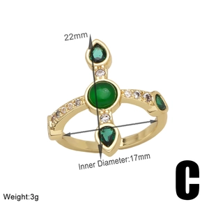 Detailed view of a gold bear ring with green gems and exact dimensions 22mm by 17mm