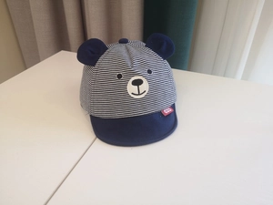 Detail of baby striped baseball cap in navy blue with 3D ears and bear embroidery