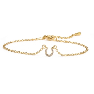 Detailed view of gold horseshoe bracelet featuring cubic zirconia and spring clasp