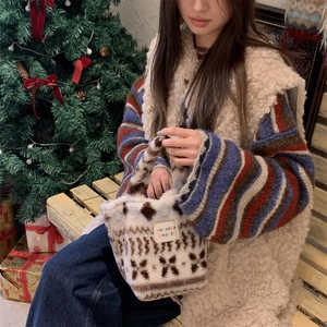 Detail of plush beige tote bag with brown retro patterns in a warm Christmas setting