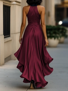 Detail of burgundy satin backless gown showing elegant flow and floor-length hemline