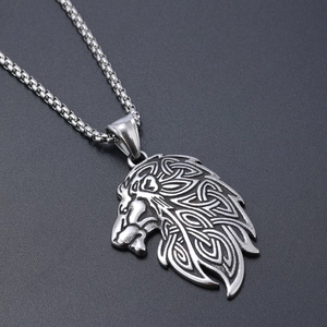 Vintage silver Viking wolf head pendant with Celtic knot patterns on a dark background