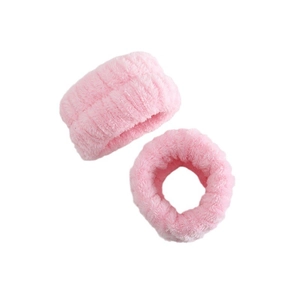 Close-up of soft pink coral fleece wrist wash bands showing plush fiber texture