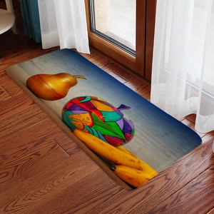 Detail of rectangular fruit pattern flannel mat on dark wood floor with sunlit background