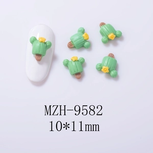 Detailed view of cactus resin nail charms sized 10x11mm on a white mannequin nail