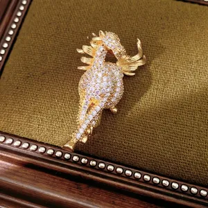 Vintage gold plated seahorse brooch with pavé zircon stones on a velvet cushion