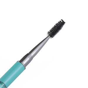 Detailed close-up of a professional black eyelash and eyebrow spoolie brush head