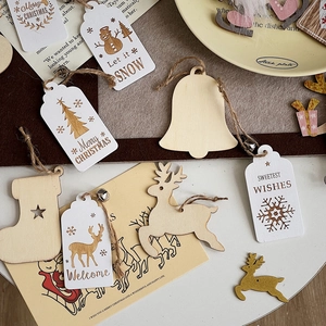 Detailed view of DIY wooden Christmas pendants with reindeer, stockings and bells