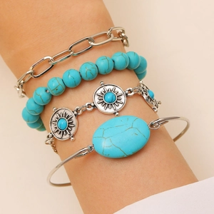Close-up of Bohemian silver bracelets with turquoise stones worn on a model's wrist