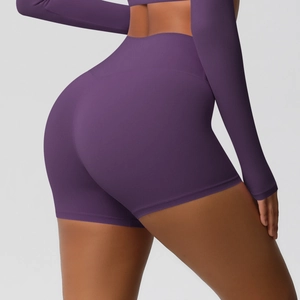 Detail showing the deep purple high-waisted yoga shorts with seamless butt lifting cut