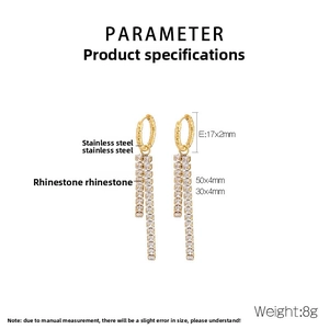 Macro detail of gold tassel earrings with rhinestones and precise dimensions