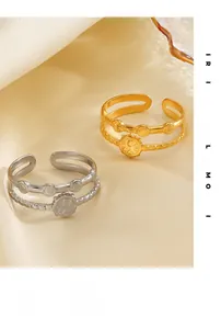 Detailed view of 18K gold plated and silver stainless steel rings with sunburst engraving