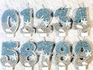 Detailed set of ocean-themed birthday candles with starfish, shells, and blue glitter