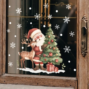Christmas window stickers with Santa, reindeer and snowflakes on a wooden glass window
