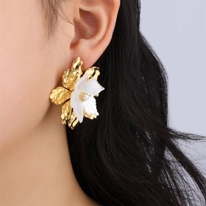 Golden stainless steel floral earrings with white layered petals and pearl on model