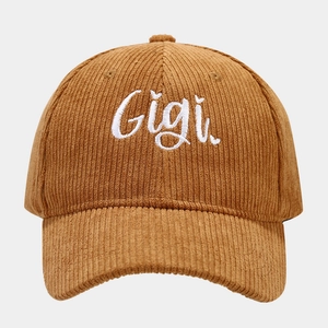 Close-up of brown corduroy baseball cap featuring white Gigi letter embroidery texture