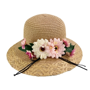 Floral straw sun hat for women with pink and white flowers and a black tie strap